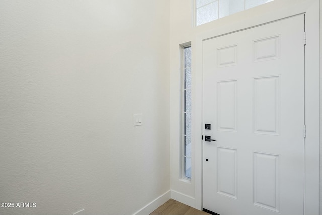 entryway featuring wood finished floors and baseboards