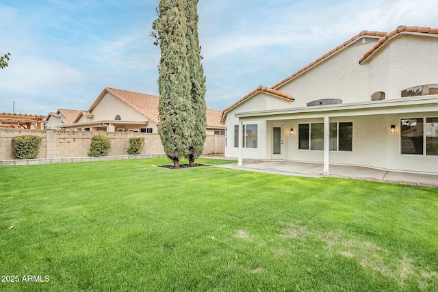 view of yard with fence and a patio