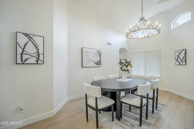 dining room with light wood-style floors, baseboards, and visible vents