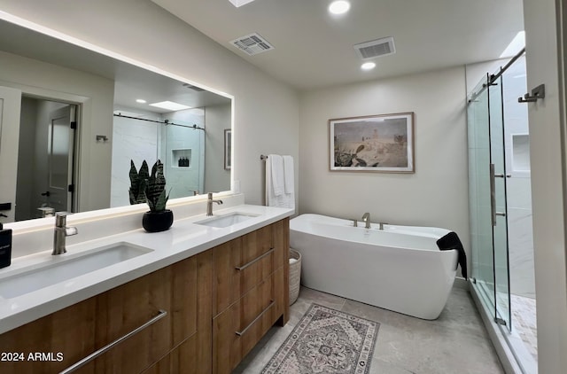 bathroom featuring double vanity, shower with separate bathtub, and tile floors