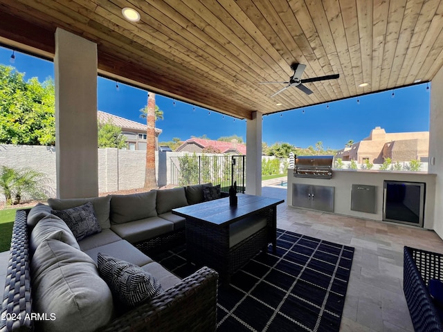 view of patio / terrace with exterior kitchen, ceiling fan, an outdoor hangout area, and grilling area