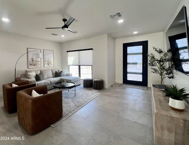 tiled living room with ceiling fan