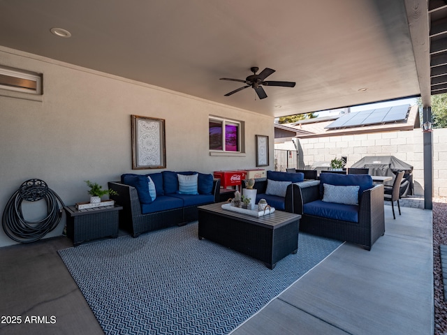 view of patio featuring an outdoor living space, ceiling fan, and fence