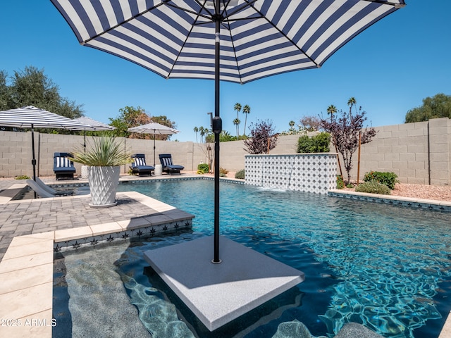 view of pool featuring a patio, a fenced in pool, and a fenced backyard