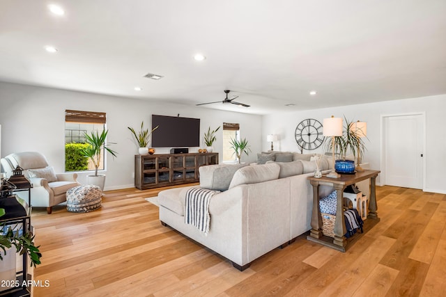 living area featuring light wood finished floors, a ceiling fan, visible vents, and recessed lighting