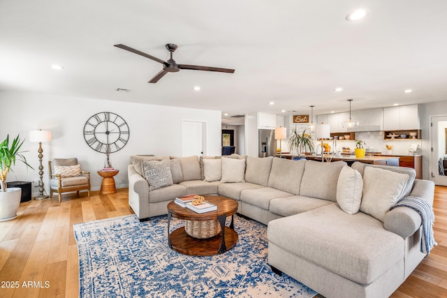 living room featuring light wood-style flooring and recessed lighting