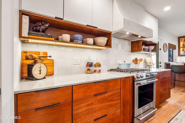 kitchen featuring open shelves, wall chimney range hood, high end stainless steel range, and modern cabinets