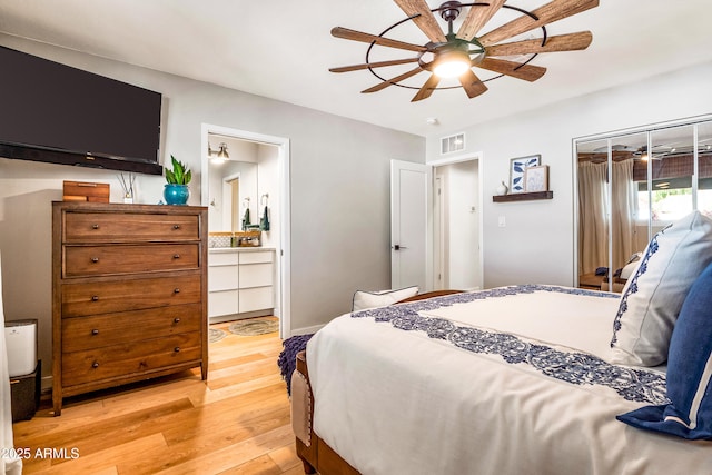 bedroom with a ceiling fan, light wood-style floors, ensuite bath, and visible vents