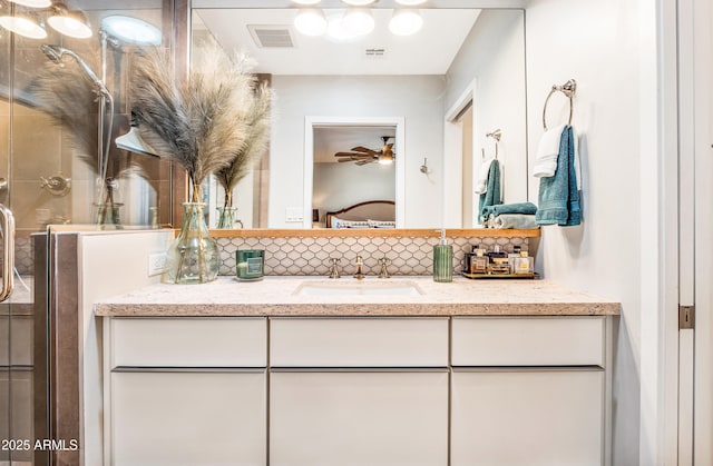 ensuite bathroom featuring a stall shower, visible vents, ensuite bath, tasteful backsplash, and vanity