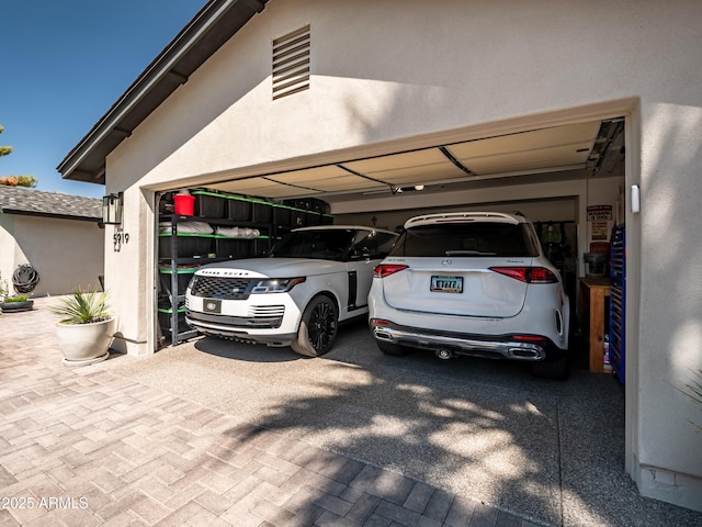 view of parking featuring a garage and driveway