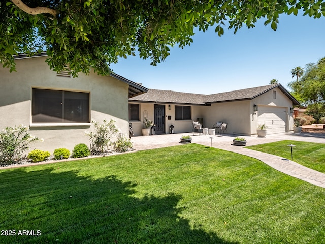 view of front facade featuring an attached garage, concrete driveway, a patio, stucco siding, and a front lawn
