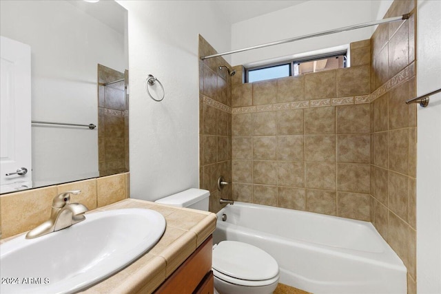 full bathroom featuring vanity, toilet, and tiled shower / bath