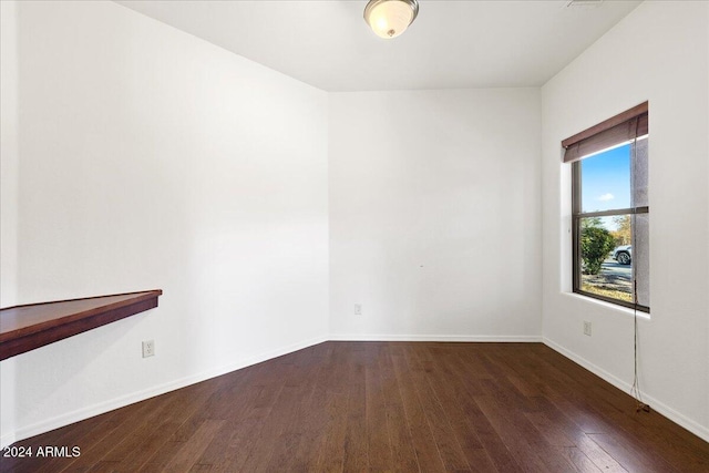 unfurnished room featuring dark hardwood / wood-style flooring