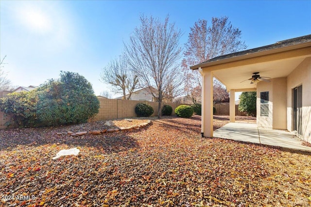 view of yard featuring ceiling fan and a patio area