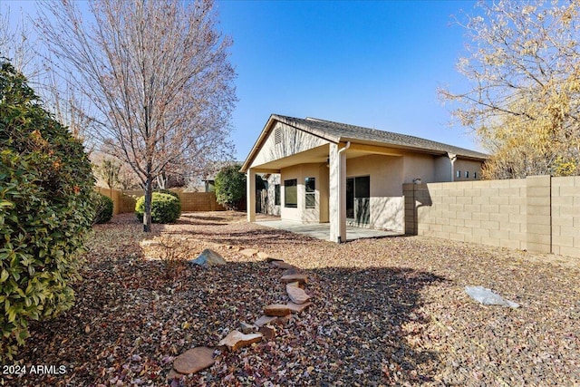 back of house with a patio