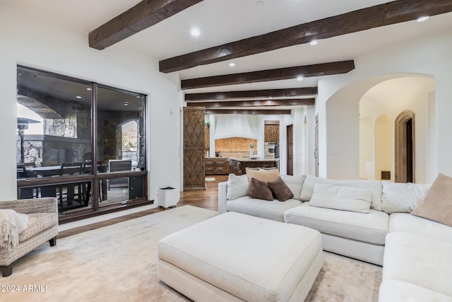 living room with beam ceiling and light wood-type flooring