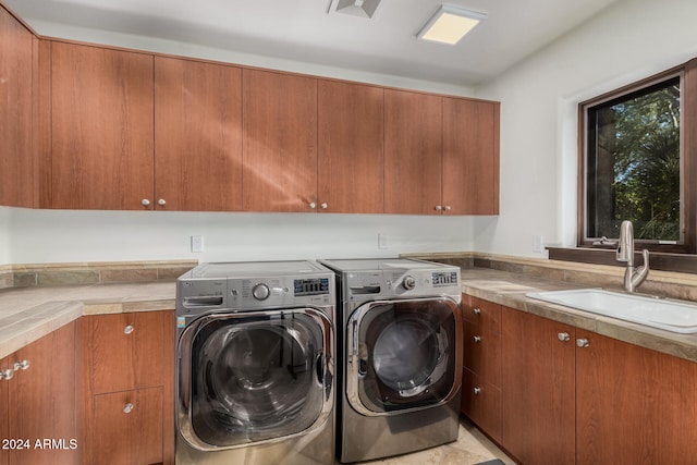 laundry area with cabinets, sink, and washing machine and dryer