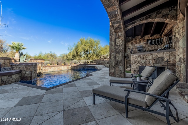 view of patio featuring pool water feature and a swimming pool with hot tub