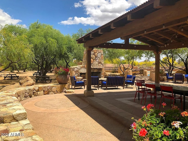 view of patio / terrace featuring a gazebo and an outdoor living space with a fireplace