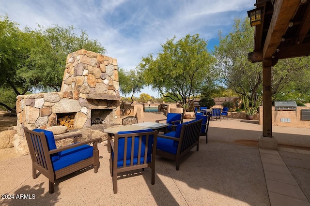 view of patio / terrace featuring grilling area, an outdoor living space, and an outdoor kitchen