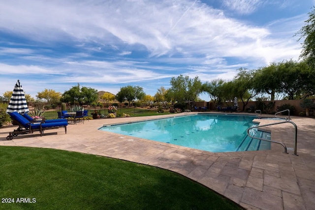 view of pool with a yard and a patio