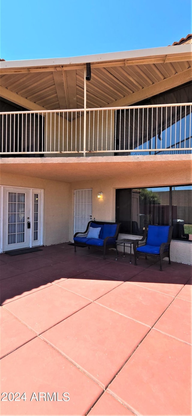 view of patio featuring a balcony and french doors