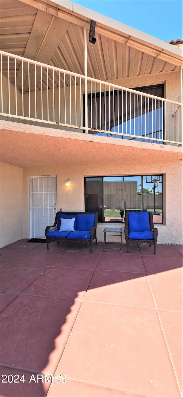 back of property with a patio area and a balcony