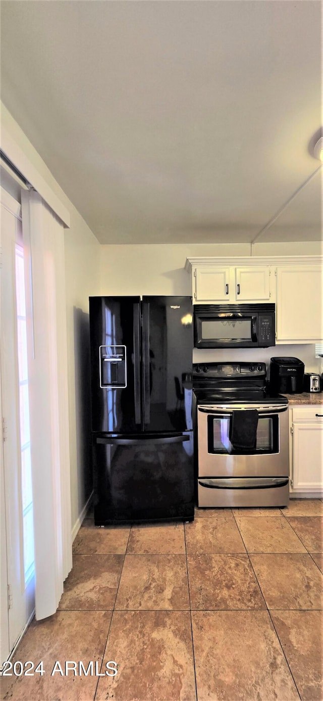 kitchen featuring black appliances, white cabinetry, and light tile patterned floors