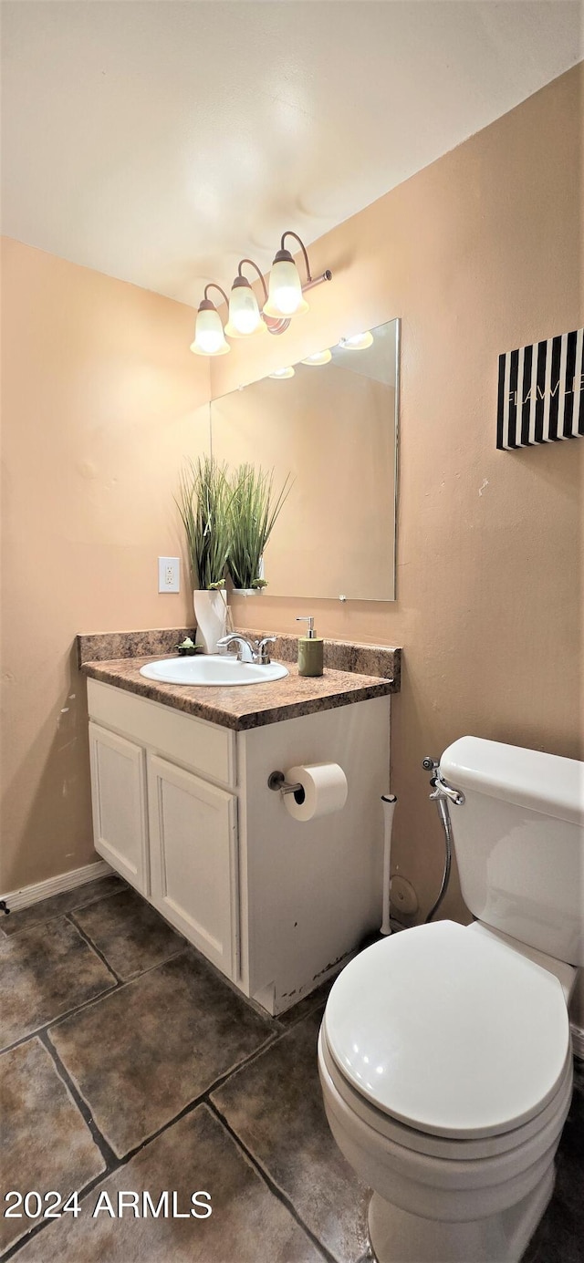 bathroom with vanity, toilet, and tile patterned floors