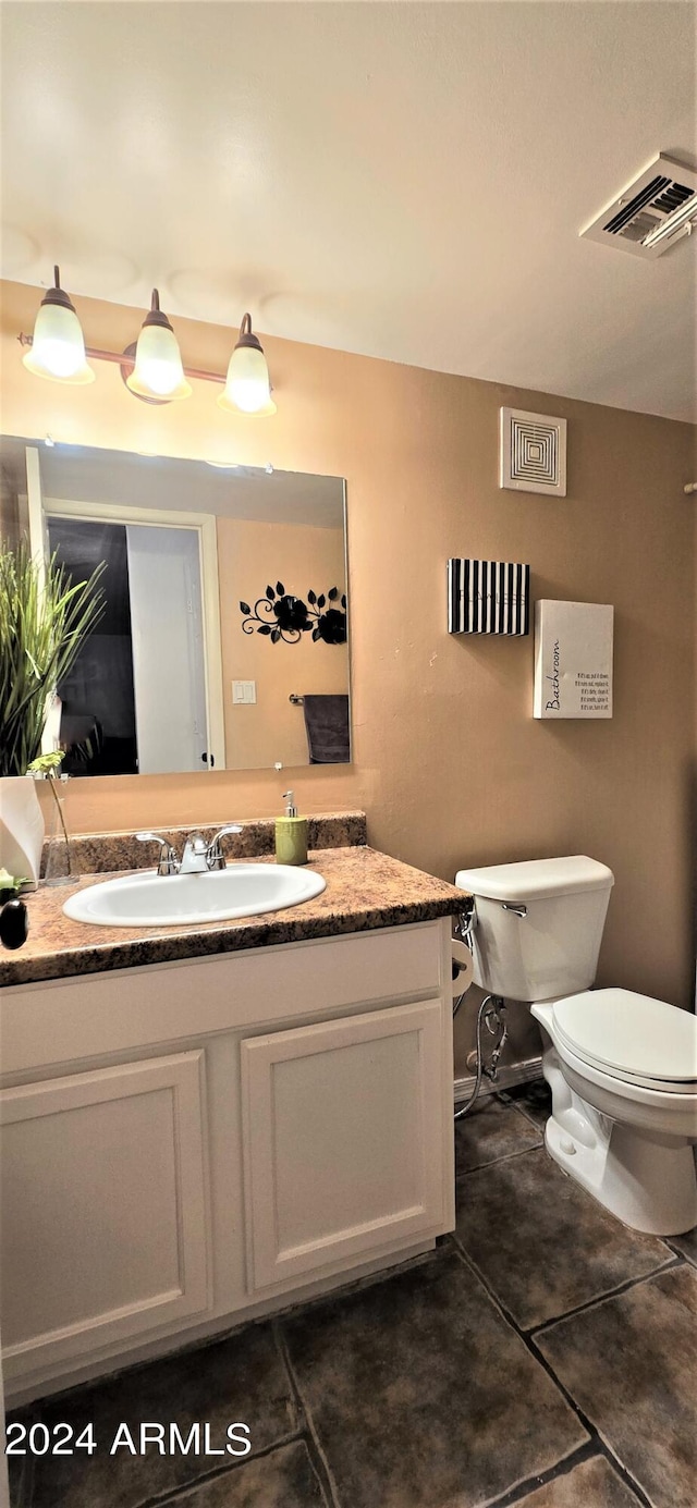 bathroom featuring vanity, toilet, and tile patterned floors