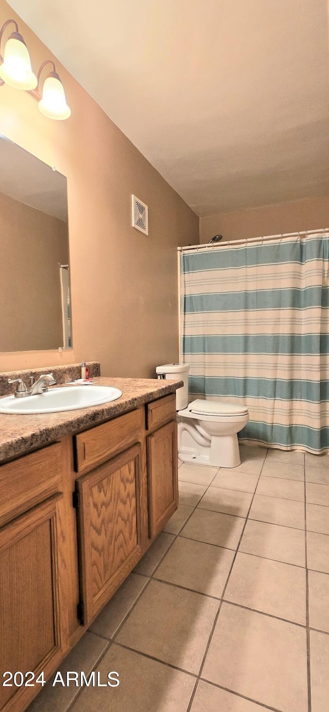 bathroom featuring vanity, toilet, curtained shower, and tile patterned flooring