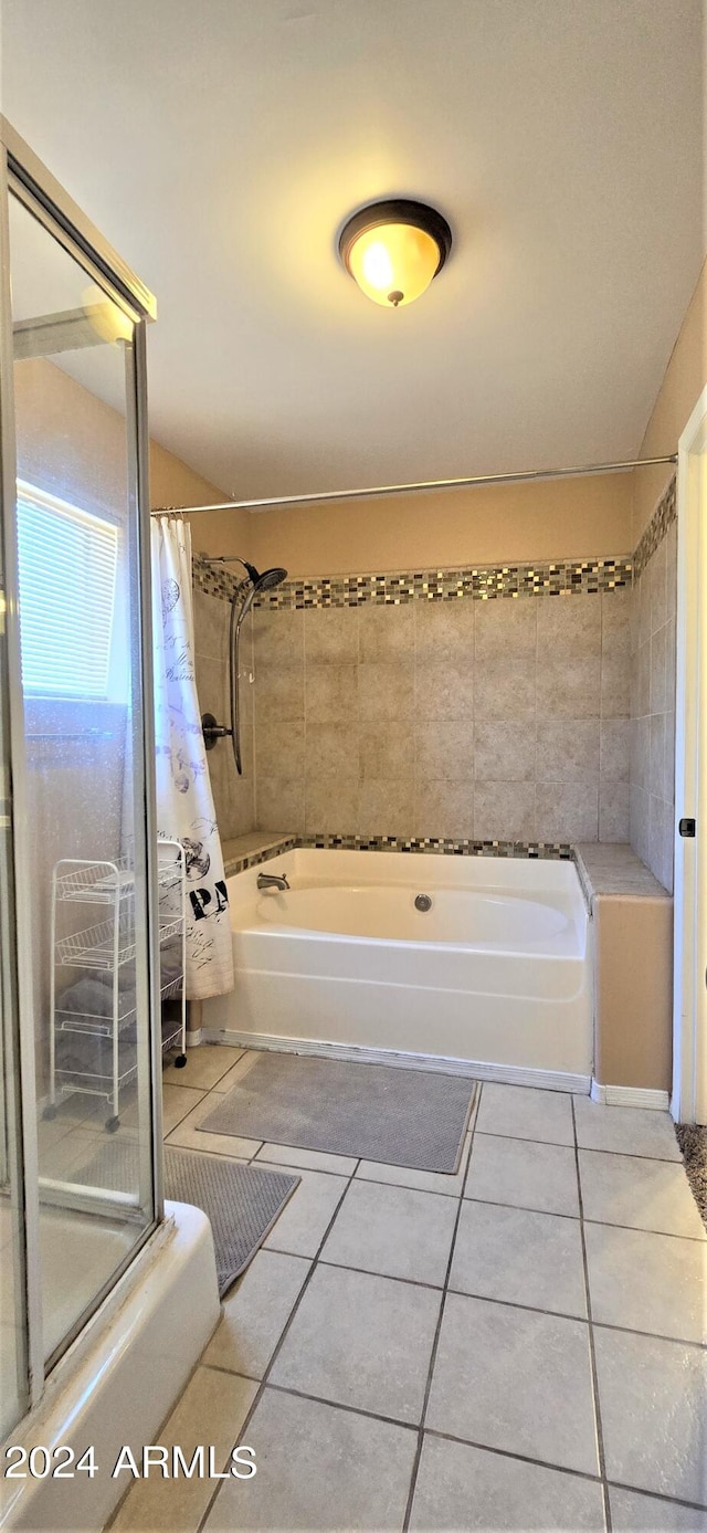 bathroom featuring tile patterned flooring and shower with separate bathtub