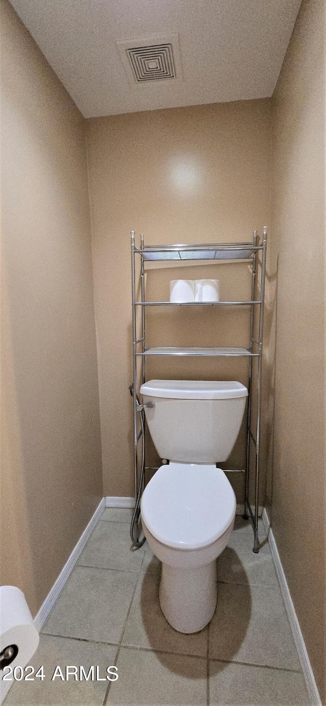 bathroom with tile patterned flooring and toilet