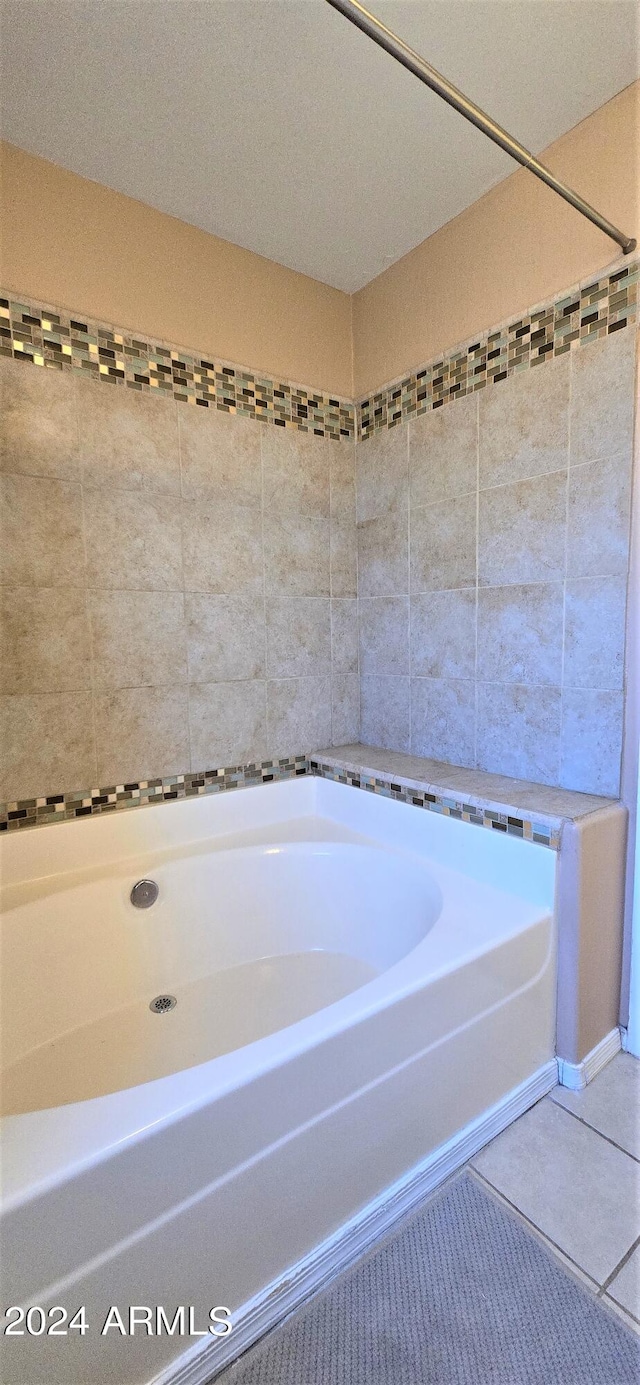 bathroom featuring a textured ceiling, independent shower and bath, and tile patterned flooring