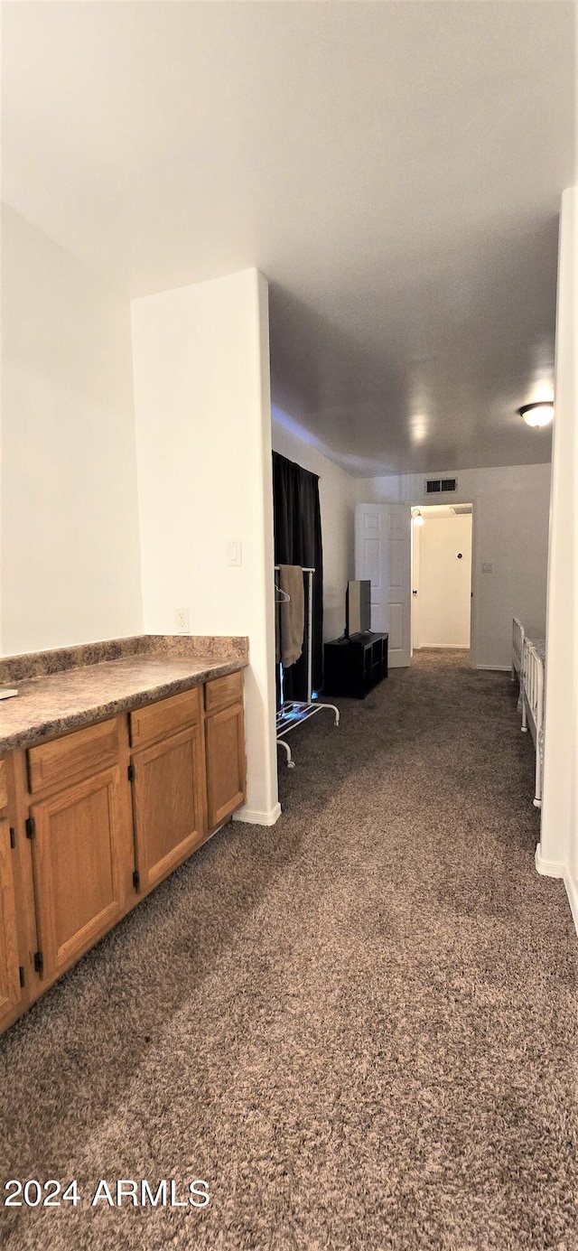 living room with dark colored carpet