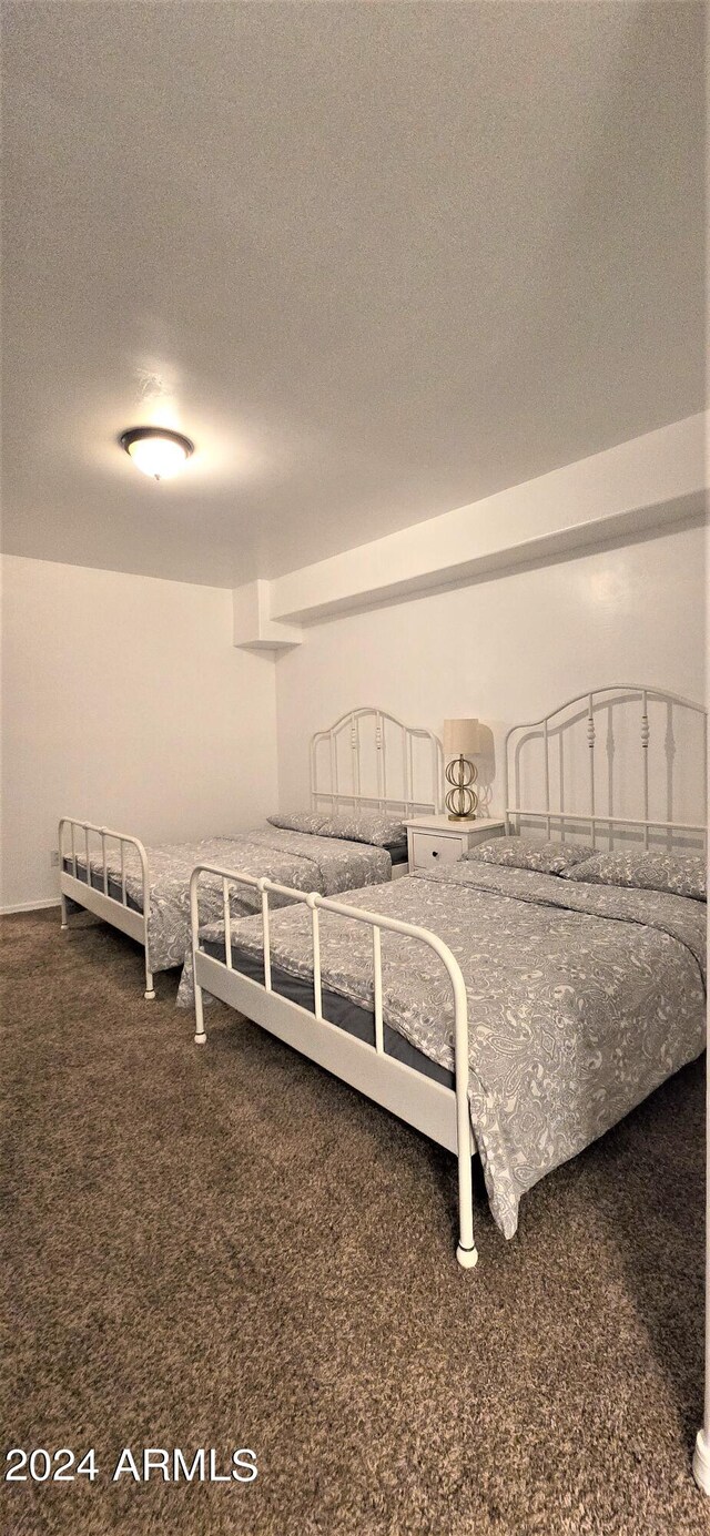 bedroom with a textured ceiling and carpet