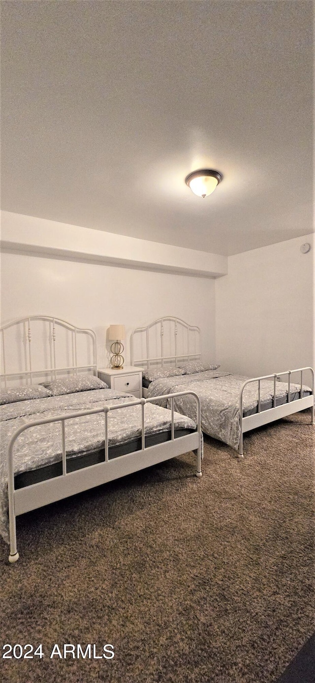 carpeted bedroom with a textured ceiling