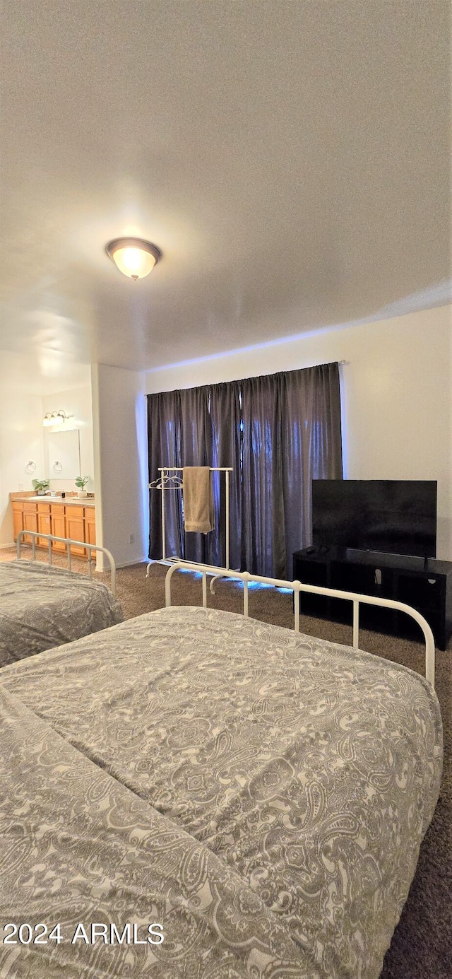 bedroom featuring a textured ceiling and carpet flooring