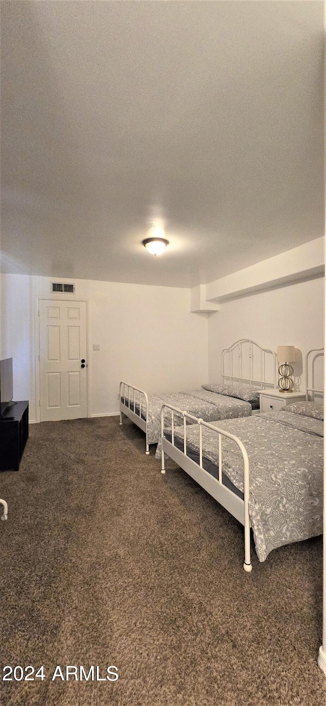 carpeted bedroom with a textured ceiling