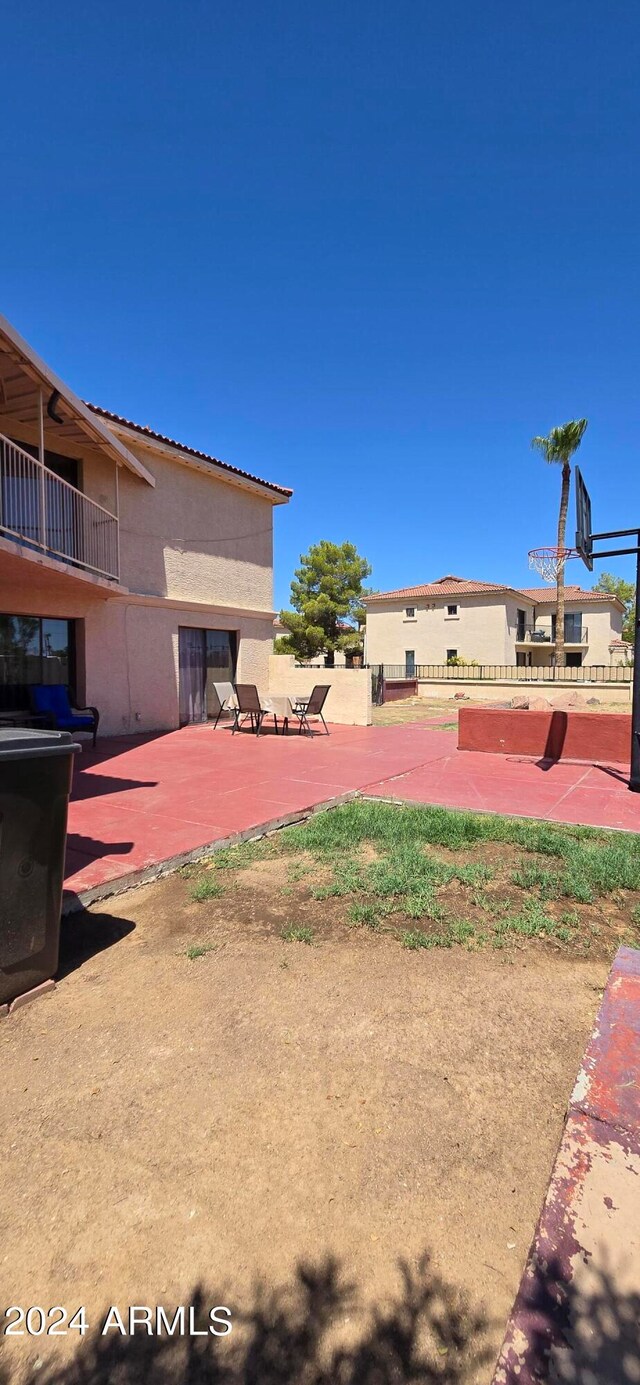 view of yard with a balcony and a patio area