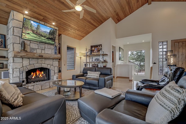 living area with wood finished floors, high vaulted ceiling, a fireplace, ceiling fan, and wooden ceiling