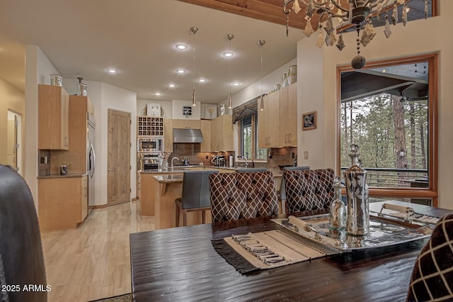 dining area featuring recessed lighting and light wood-style floors