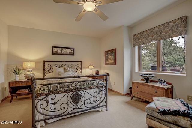 bedroom featuring a ceiling fan, baseboards, and light carpet