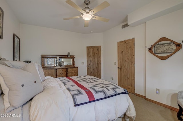 bedroom with a ceiling fan, visible vents, light colored carpet, and baseboards