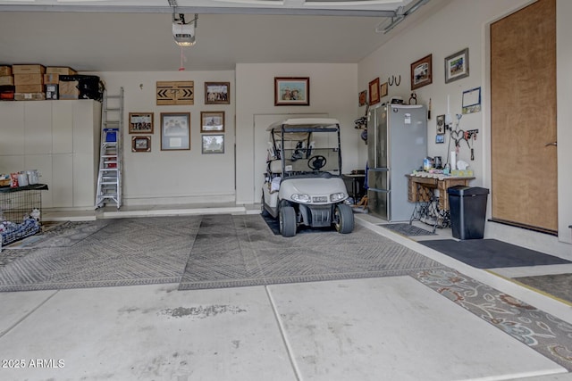 garage with a garage door opener and freestanding refrigerator