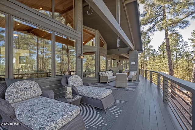 wooden terrace with an outdoor hangout area