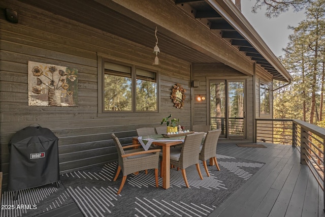 wooden terrace featuring outdoor dining area