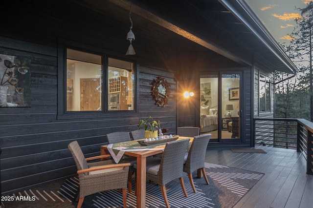 wooden deck featuring outdoor dining area