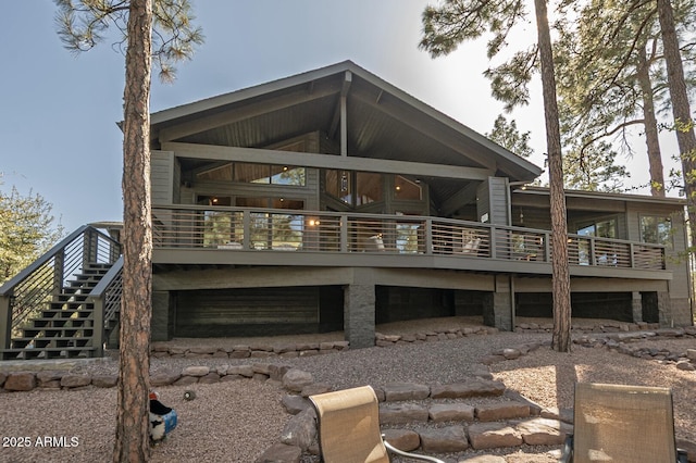 rear view of property featuring stairway