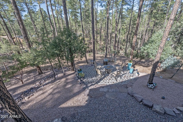 view of yard featuring an outdoor fire pit and a patio area